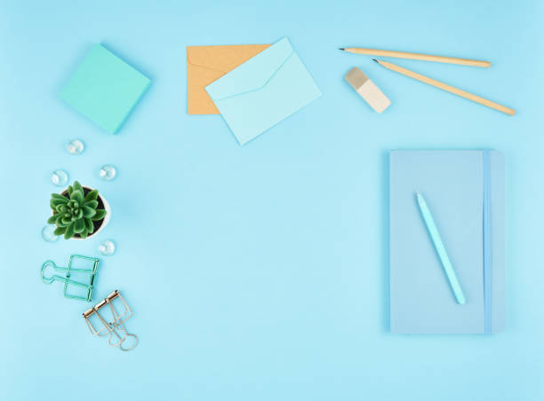 istock Blue office desktop. Top view of modern bright table with office supplies. Mock up, copy space 1127690382