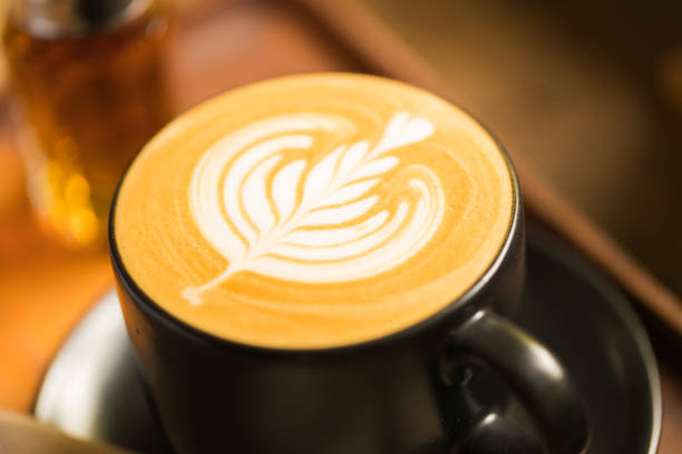 Coffee cup with latte art at coffee shop stock photo
