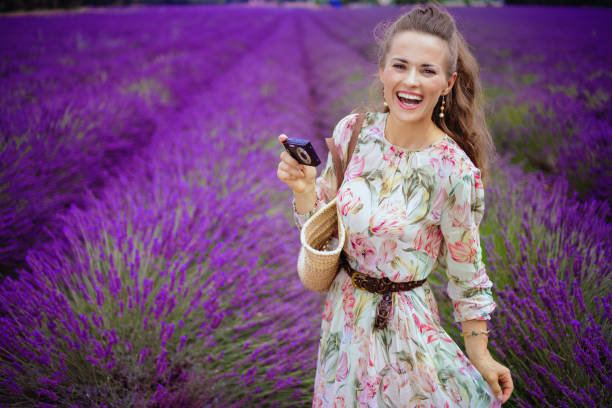 istock woman in lavender field taking photo with digital camera 1127692652