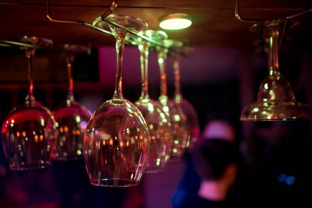 istock Glasses hanging over a bar rack 1127693671