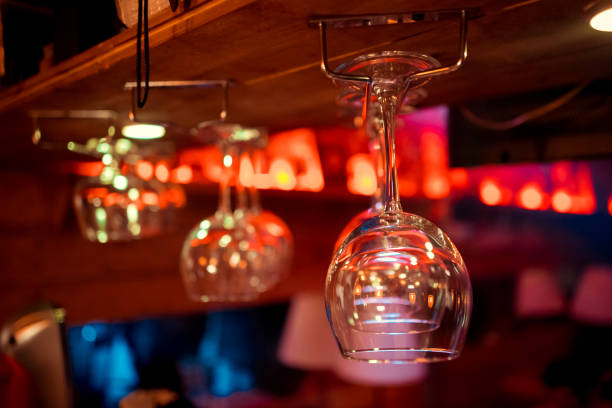 istock Glasses hanging over a bar rack 1127693696
