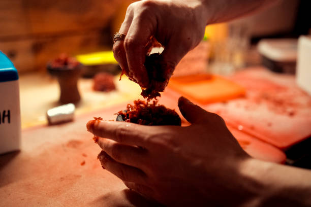 istock Shisha hookah preparing by barman. Bartender lays tobacco for smoking 1127693790
