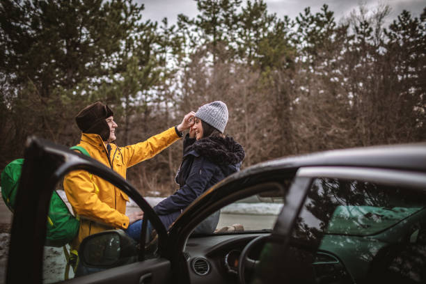 istock Yong couple resting on a car 1127696711