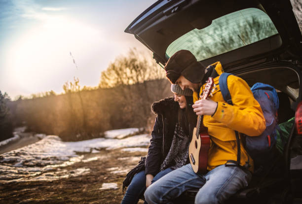 istock Yong couple with guitar in car trunk 1127696728