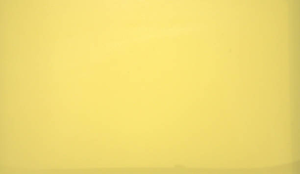 istock Yellow glossy monophonic background. Metallic. Texture. Close-up shot. 1127696817