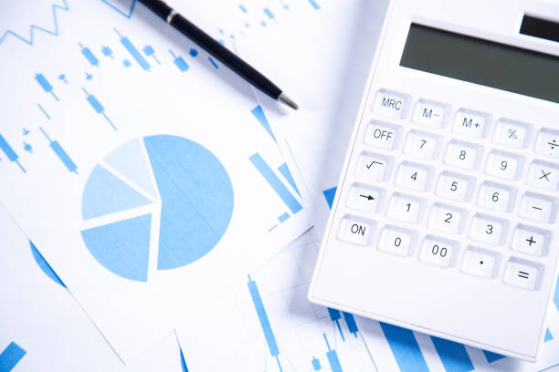 istock Calculator and pen with financial graphs. 1127697857