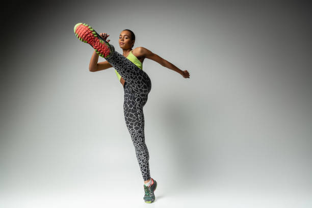 istock Delighted young sportswoman doing gymnastics in morning 1127698638