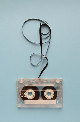 Vintage audio cassette tape on blue background