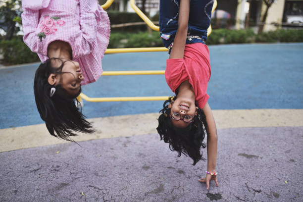 istock Girl upside down on the jungle gym 1127704361