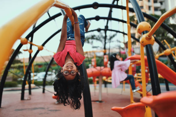 istock Girl upside down on the jungle gym 1127705002