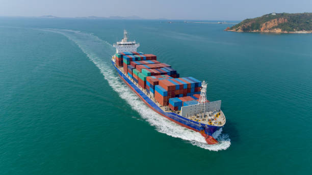 istock Aerial view container ship going to sea port for unload container. Logistic, import export, shipping or transportation. 1127705046