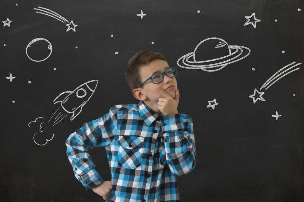 istock Young boy child think idea dreaming imagination space stars 1127705593