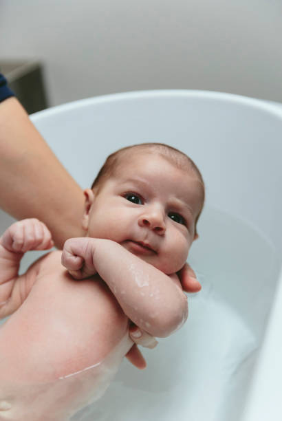 istock Newborn in the bathtub looking at camera 1127706364