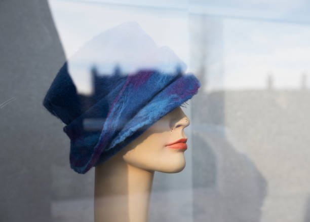 istock female dummy with blue woolen hat in display window 1127707072
