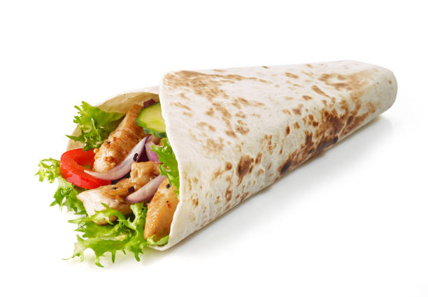 Tortilla wrap with fried chicken meat and vegetables Tortilla wrap with fried chicken meat and vegetables isolated on white background fajita photos stock pictures, royalty-free photos & images