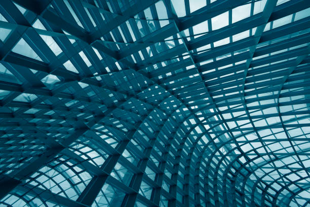 istock Digitally rendered image of futuristic architecture fragment with metal framework and structural glazing. Curvilinear multilayer grid structures. Abstract architectural or industrial background in hi-tech style. 1127714259