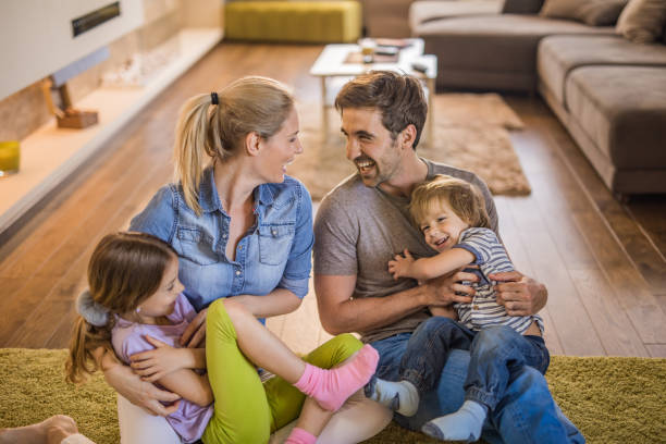 istock Young happy parents having fun while tickling their kids at home. 1127715348