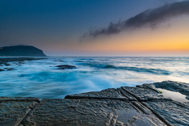 istock Sunrise Seascape and Tesselated Rock Ledge 1127716887