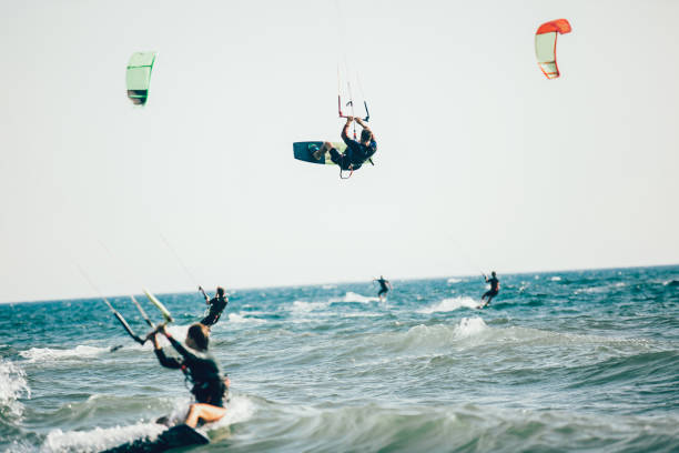 istock Athletic man riding on kite surf board 1127717058