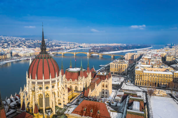 Budapest, Hungary - Winter morning over Budapest Parliament building, snowy rooftops, Margaret Bridge, Margaret Island and Buda Hills stock photo