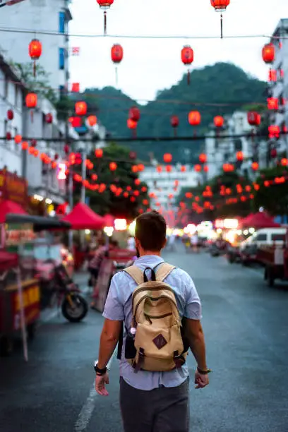 Photo of Traveler exploring Asian food market street