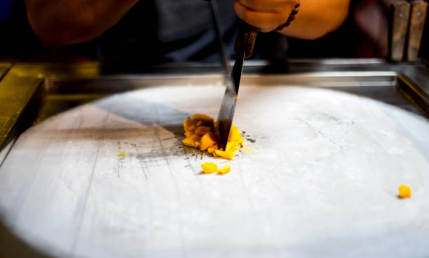 istock Man making ice cream rolls in the food market 1127721693