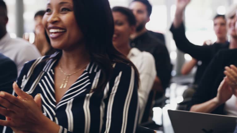 4k footage of a group of businesspeople clapping hands while sitting in a conference