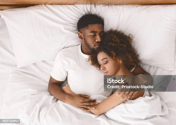 Young Black Couple Sleeping Together In Bed Stock Photo - Download Image Now - Couple - Relationship, Sleeping, Bed - Furniture