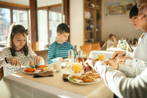 istock Family at breakfast in hotel restaurant 1127726328