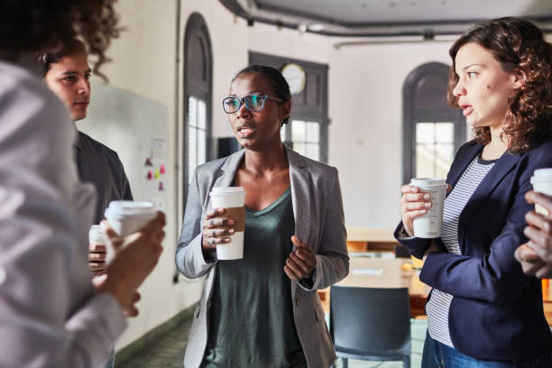 istock Businesswoman discussing while having coffee with colleague 1127726437