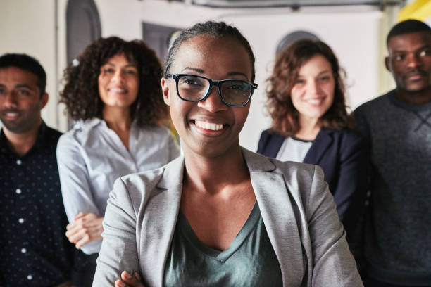 istock Successful business woman with her team at the back 1127726438