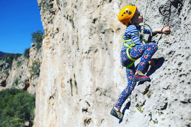 Guy climbing in Greece and beautiful forest and cliff landscape on the background