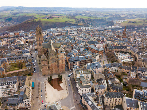 Aerial view of French city of Rodez with tower of Cathedral and spire of church of Saint Amans in autumn day
