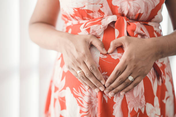 istock Pregnant woman making heart shape. 1127729307