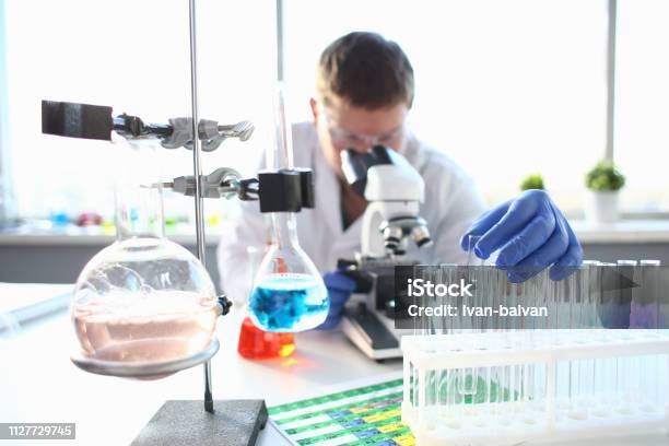 Portrait Of A Young Chemist Looking In Binocular Stock Photo - Download Image Now - Pharmacy, Research, Allergy
