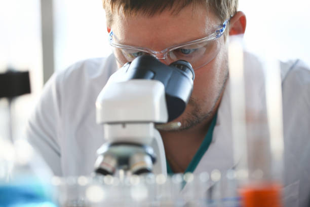 istock Portrait of a young chemist looking in binocular 1127729751