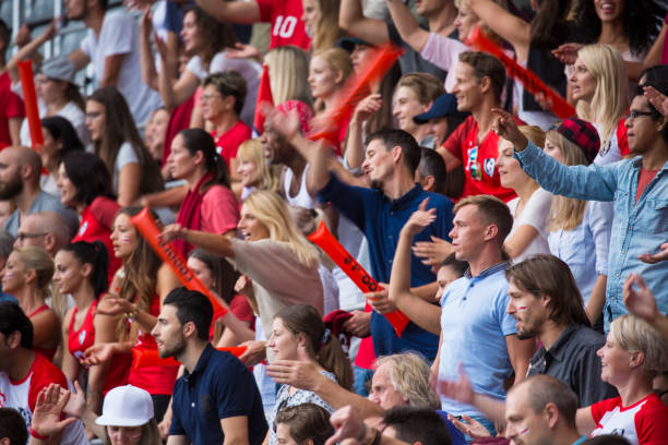 istock Group of spectators cheering in stadium 1127730061