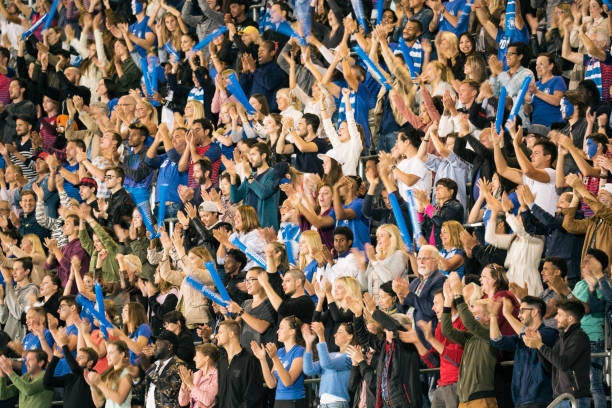 istock Group of spectators cheering in stadium 1127730064