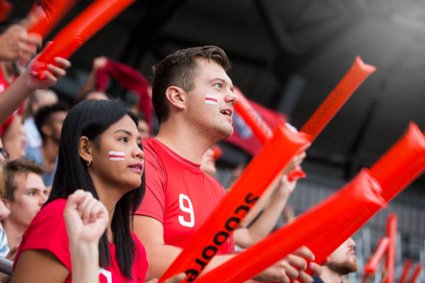istock Man and woman watching match in stadium 1127730067