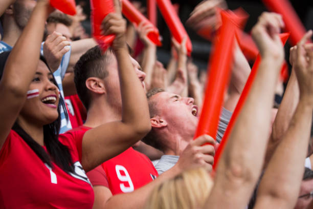 istock Group of spectators cheering in stadium 1127730068