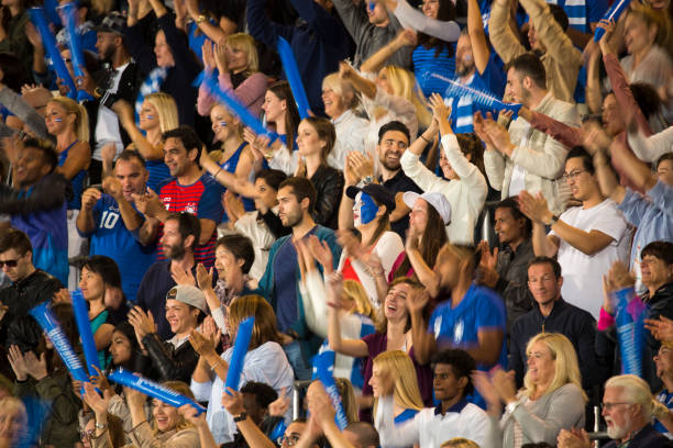 istock Group of spectators cheering in stadium 1127730069