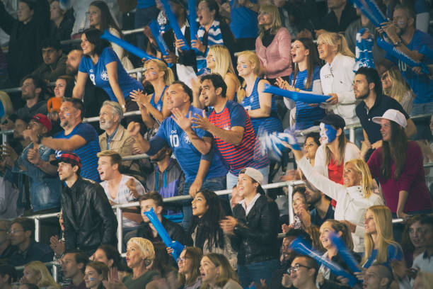 istock Group of spectators cheering in stadium 1127730071