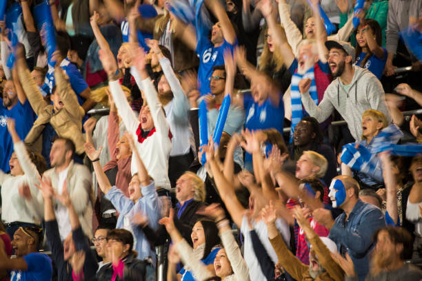 istock Group of spectators cheering in stadium 1127730076