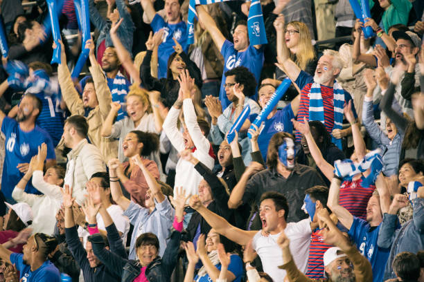 istock Group of spectators cheering in stadium 1127730079