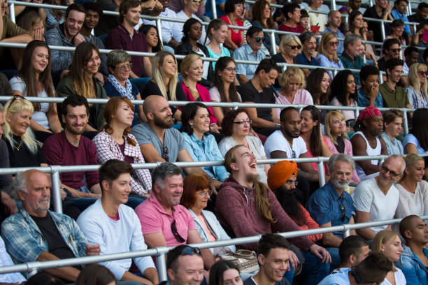 istock Cheerful spectators sitting in stadium 1127730085