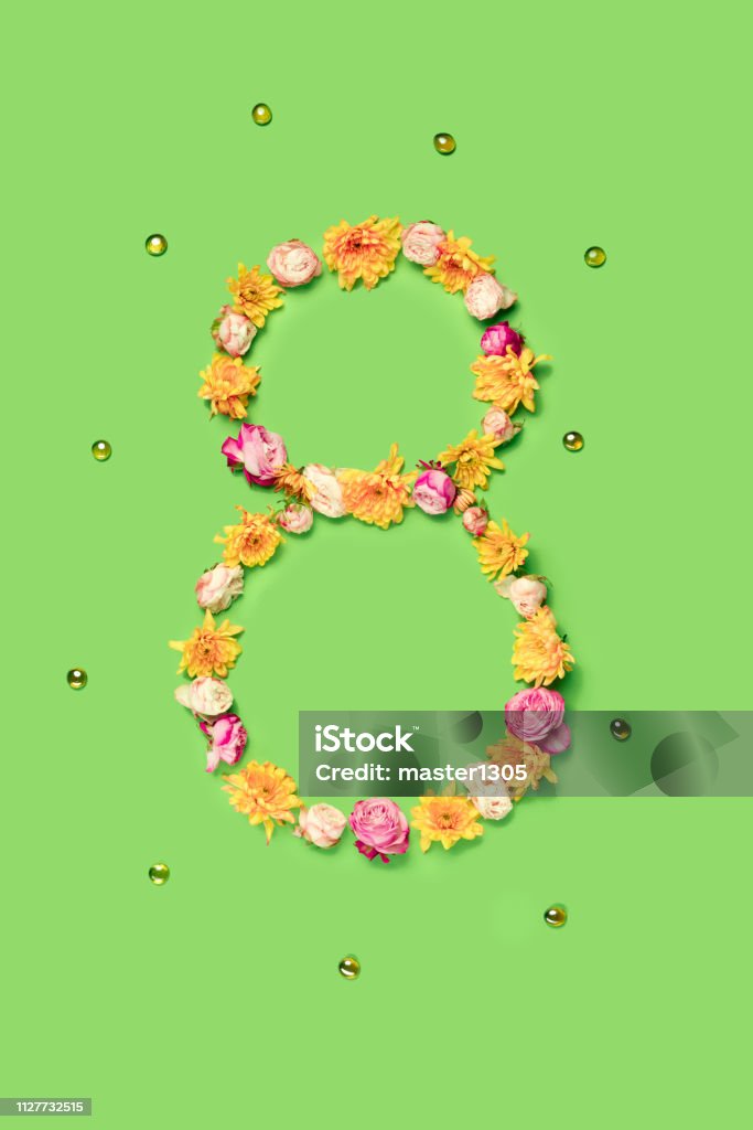 The flowers composition about eights march woman's day, holiday. The conceptual composition from flowers about Eights march woman's day, holiday on a green background. The number 8 in decor. Top view Adult Stock Photo