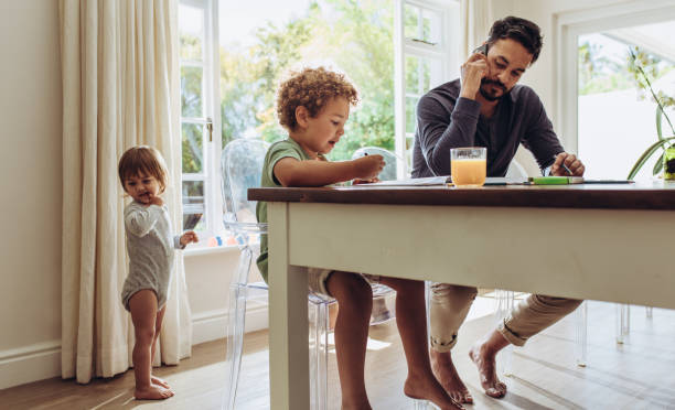 istock Man looking after kids at home 1127732877