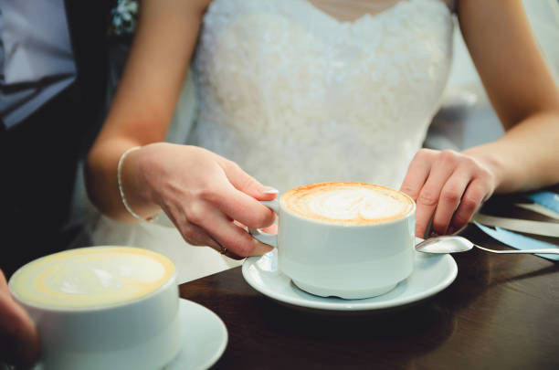 istock Bride and groom on their wedding day, drink coffee in a cafe. 1127733190