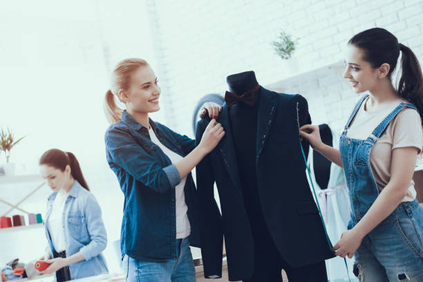 istock Women work with suit and looking on each other. 1127734257