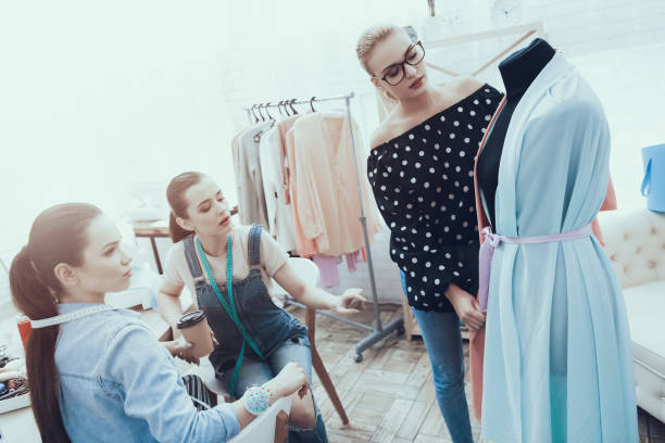 istock Designer Woman matches material with dress. 1127734281